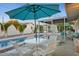 A backyard featuring a pool, patio furniture, and a shaded umbrella, ideal for outdoor enjoyment at 421 N Evergreen St, Chandler, AZ 85225