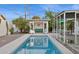 The backyard is featuring a pool nestled between an outdoor lounge and a covered patio, ideal for entertaining at 421 N Evergreen St, Chandler, AZ 85225