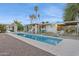 Inviting backyard features a pristine pool, shaded lounge, and covered seating, all designed for relaxation at 421 N Evergreen St, Chandler, AZ 85225