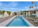 A tranquil pool is centrally located between a charming lounge area and covered patio, perfect for relaxation at 421 N Evergreen St, Chandler, AZ 85225
