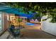 Inviting backyard features a well-maintained pool, covered patio area, and outdoor seating under a shady tree at 421 N Evergreen St, Chandler, AZ 85225