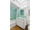 Cozy bathroom featuring vintage green tile, bathtub and shower, with a skylight adding natural light at 421 N Evergreen St, Chandler, AZ 85225