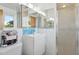 Bright bathroom featuring a modern white sink, mirrored cabinets, and walk-in shower at 421 N Evergreen St, Chandler, AZ 85225