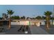 A stunning twilight view of a well-kept home featuring a covered carport, desert landscaping and an eye-catching blue door at 421 N Evergreen St, Chandler, AZ 85225
