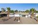 Charming home featuring a covered carport, xeriscaped yard and eye-catching blue door at 421 N Evergreen St, Chandler, AZ 85225