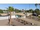 Eye-level view of a well-kept home featuring a covered carport, xeriscaped yard and eye-catching blue door at 421 N Evergreen St, Chandler, AZ 85225