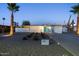 Charming mid-century modern home featuring a neatly landscaped front yard, stylish exterior, and well-lit pathway at 421 N Evergreen St, Chandler, AZ 85225