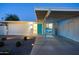 Inviting front exterior with a turquoise door, white brick, manicured landscaping, and covered carport entrance at 421 N Evergreen St, Chandler, AZ 85225