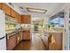 Kitchen with warm wood cabinets, stainless steel appliances, and ample natural light at 421 N Evergreen St, Chandler, AZ 85225