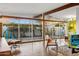 Spacious living room with floor-to-ceiling windows offering panoramic views of the lush backyard and patio area at 421 N Evergreen St, Chandler, AZ 85225