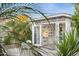Bright backyard office featuring glass desk, picture gallery and white painted exterior and french doors at 421 N Evergreen St, Chandler, AZ 85225