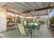 Covered patio featuring a glass-top table, modern chandelier, and seamless indoor-outdoor flow through large glass windows at 421 N Evergreen St, Chandler, AZ 85225