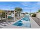Inviting backyard featuring a sparkling pool, covered patio with seating, and manicured landscaping on a sunny day at 421 N Evergreen St, Chandler, AZ 85225