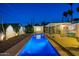 Stunning backyard pool at night, featuring lounge areas and decorative lighting at 421 N Evergreen St, Chandler, AZ 85225