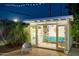 Charming backyard studio with glass doors and white trim offers a flexible space, surrounded by lush greenery at 421 N Evergreen St, Chandler, AZ 85225