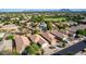 Aerial view of neighborhood homes with pools, landscaping, and mountain views at 4251 E Sundance Ave, Gilbert, AZ 85297