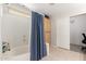 Bathroom with shower, storage cabinet, linen closet and neutral tile floors at 4251 E Sundance Ave, Gilbert, AZ 85297