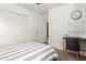 Cozy bedroom features gray and white striped bedding, a desk, and a whiteboard at 4251 E Sundance Ave, Gilbert, AZ 85297