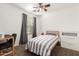 Comfortable bedroom setup with gray curtains, desk, and a ceiling fan at 4251 E Sundance Ave, Gilbert, AZ 85297