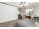 Bedroom with wardrobe cabinet, neutral carpet, and plenty of natural light from surrounding windows at 4251 E Sundance Ave, Gilbert, AZ 85297