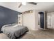 Spacious bedroom with plush carpet, ceiling fan, large window, and ensuite bathroom at 4251 E Sundance Ave, Gilbert, AZ 85297