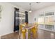Bright dining area featuring a wooden table, yellow chairs, and sliding glass doors to the backyard at 4251 E Sundance Ave, Gilbert, AZ 85297