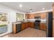 Bright kitchen with wood cabinets, stainless appliances, stone counters, and a door to the backyard at 4251 E Sundance Ave, Gilbert, AZ 85297