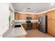 Bright kitchen showcasing wood cabinets, granite countertops, stainless appliances and neutral tile floors at 4251 E Sundance Ave, Gilbert, AZ 85297