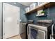 Well-equipped laundry room with modern washer and dryer and attractive storage solutions at 4251 E Sundance Ave, Gilbert, AZ 85297