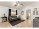 Cozy living room featuring tile flooring, a comfortable sofa, and stylish decor at 4251 E Sundance Ave, Gilbert, AZ 85297