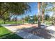 A colorful playground with swings and slides in a green park area at 4251 E Sundance Ave, Gilbert, AZ 85297