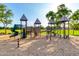 Community playground featuring multiple slides, climbing structures, and a spring rider surrounded by sand at 4251 E Sundance Ave, Gilbert, AZ 85297