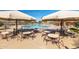 Outdoor pool area with a splash pad, lounge chairs, tables, and shade umbrellas at 4251 E Sundance Ave, Gilbert, AZ 85297
