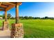 View from pavilion looking out to a large green grassy common area and blue skies at 4251 E Sundance Ave, Gilbert, AZ 85297