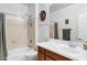Classic bathroom features a shower-tub combo and traditional vanity with decor at 42711 W Darter Dr, Maricopa, AZ 85138