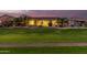 Exterior shot of backyard with pavers, desert landscaping and golf course behind at 42711 W Darter Dr, Maricopa, AZ 85138