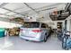 Organized garage featuring a minivan, golf cart, bicycles and ceiling storage racks at 42711 W Darter Dr, Maricopa, AZ 85138