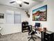 Functional home office setup with a scenic painting and a comfortable office chair at 42711 W Darter Dr, Maricopa, AZ 85138