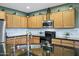 Modern kitchen featuring stainless steel appliances and ample cabinet space at 42711 W Darter Dr, Maricopa, AZ 85138
