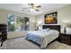 Comfortable main bedroom featuring a large window with views to the landscape outside at 42711 W Darter Dr, Maricopa, AZ 85138