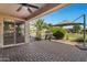 Outdoor patio with pavers, grill, desert landscaping, and an umbrella for shade at 42711 W Darter Dr, Maricopa, AZ 85138