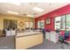Well-lit sewing room with individual workstations, cabinets, and comfortable seating for creative projects at 42711 W Darter Dr, Maricopa, AZ 85138