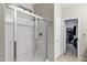 Bathroom featuring a glass-enclosed shower and access to a spacious walk-in closet at 42711 W Darter Dr, Maricopa, AZ 85138