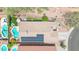 Aerial view of a home with solar panels, a pool, lush landscaping, and outdoor furniture at 4301 E Abraham Ln, Phoenix, AZ 85050