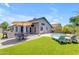 Gorgeous backyard oasis featuring a refreshing pool, manicured lawn, outdoor kitchen, and comfortable lounge area at 4301 E Abraham Ln, Phoenix, AZ 85050