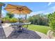Charming backyard with brick-paved patio, comfortable seating, lush greenery and pool at 4301 E Abraham Ln, Phoenix, AZ 85050