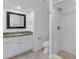 Bathroom featuring granite countertops, a stand-up shower, and neutral-color tile flooring at 4301 E Abraham Ln, Phoenix, AZ 85050