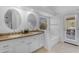 Bright bathroom features double vanity, granite counters, tile floors, and tub, with natural light streaming in at 4301 E Abraham Ln, Phoenix, AZ 85050