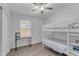 Bright bedroom with bunk beds, a desk, a ceiling fan, and wood-style flooring at 4301 E Abraham Ln, Phoenix, AZ 85050