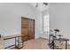 Bright bedroom boasts hardwood floors, arched window with built-in seating, and double doors at 4301 E Abraham Ln, Phoenix, AZ 85050